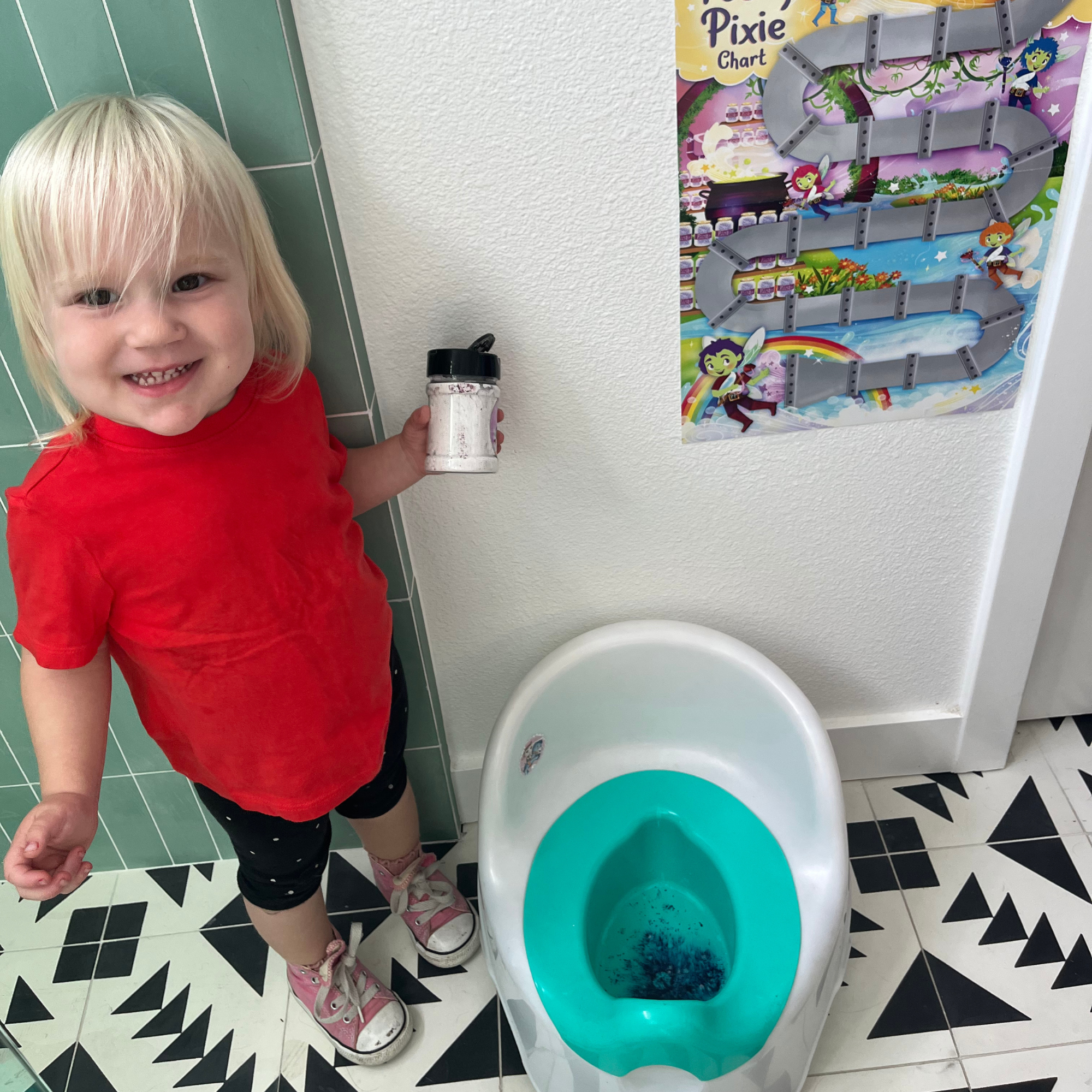 Child using the Potty Pixie Dust and showing the bright colors it makes after potty training. 